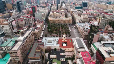 aerial orbit establishing of the plaza de armas of santiago, center of the capital of chile, morning with soft light, garden in the middle of the city