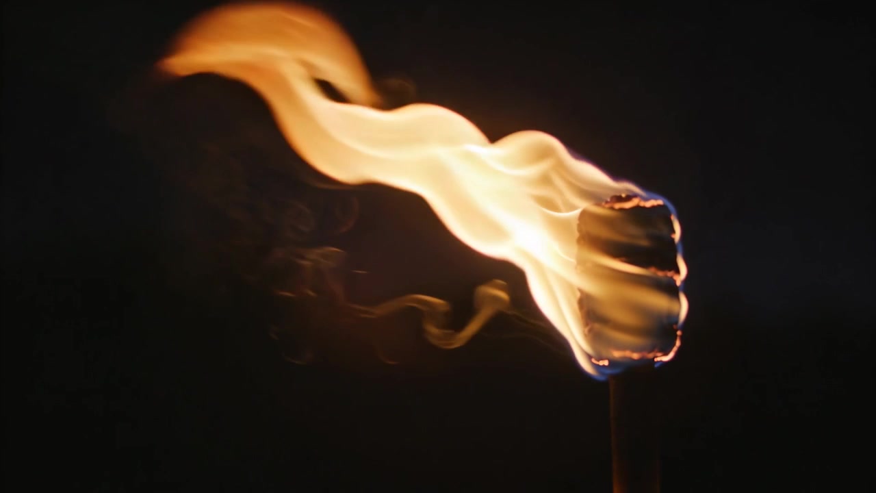 Burning treated match after striking stretching flame left in dark closeup smoke trails, copy space
