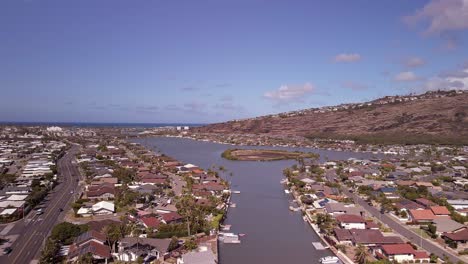 aerial view of kuapa pond with clouds and blue skies tracking forward