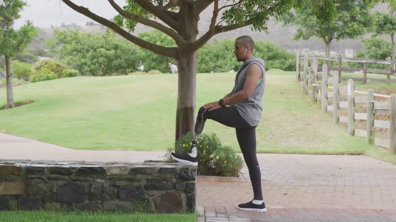Side view man with prosthetic leg stretching