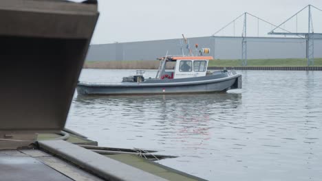 sailor waiting for a boat slowly getting launched into the water banks