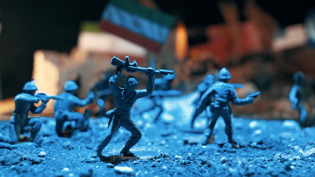Plastic toy soldiers reenacting a battle scene on a miniature battlefield. Blue police and warm fire lights flashing over the war diorama