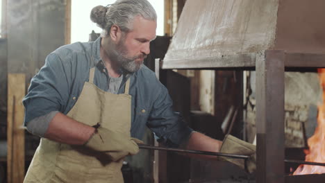 Blacksmith-Working-with-Fire-in-Forge