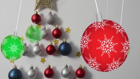 Animation-of-hanging-colorful-christmas-baubles-decorations-against-grey-background