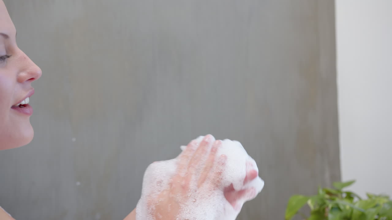 Washing hands with soap, young girl enjoying spa treatment, feeling relaxed, copy space