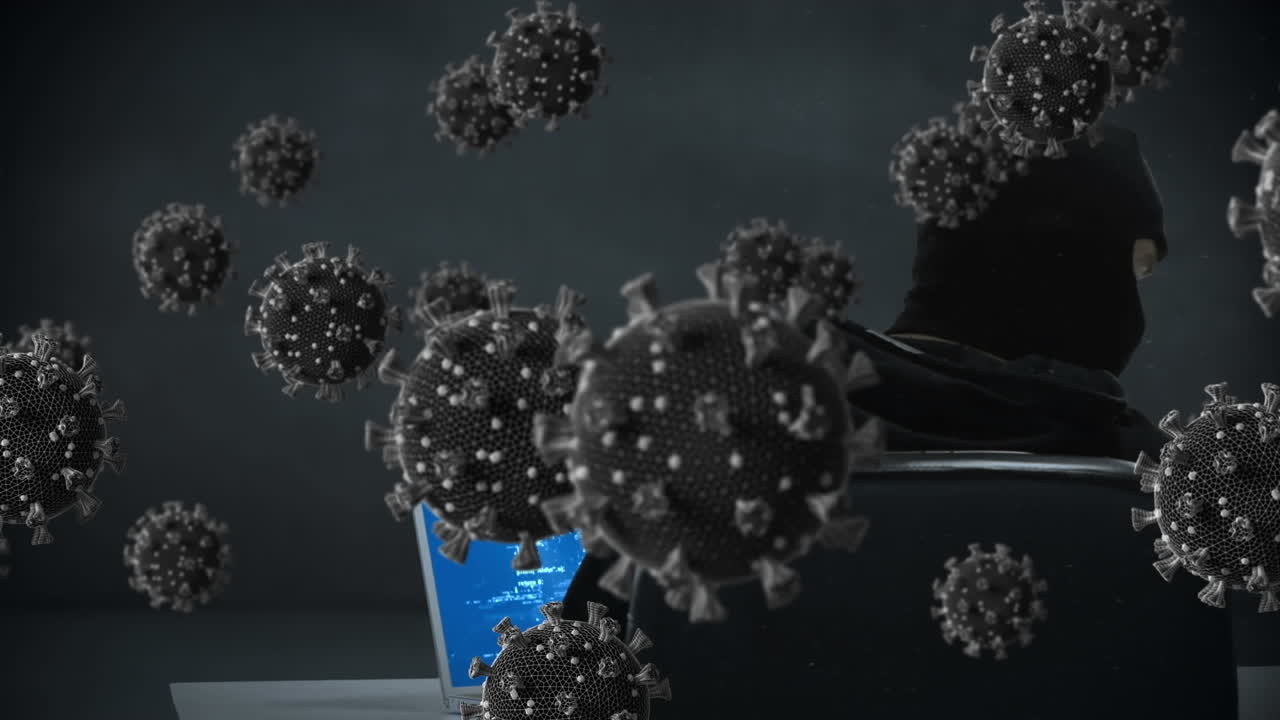 animación de las células macro covid19 sobre un hombre que lleva una balaclava, usando una computadora portátil