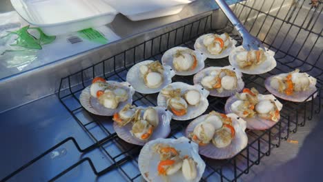 grilled-scallop-cooked-in-grill-on-hot-coal-ready-to-serve-at-street-food-process-kitchen-Pattaya