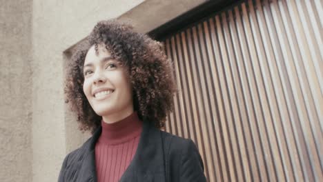 A-curly-girl-in-a-suit-looking-around-in-the-city-of-Bogota,-Colombia