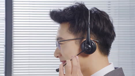 man wearing a headset working in a call center