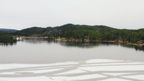 Northern-lake-with-ice-and-snow-on-it-aerial-shot