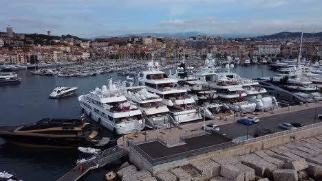 Close-up-drone-shot-expensive-luxury-yachts-and-boats-docked-in-Cannes