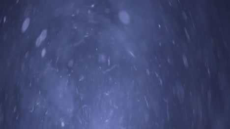 partículas de fondo azul abstracto y bokeh flotando en el espacio