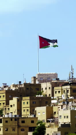 jordan flag flying over amman city