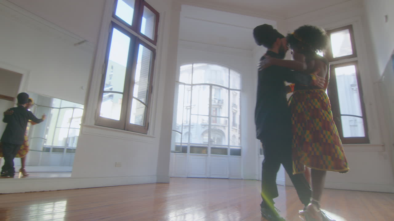 Couple Dancing Argentine Tango in Sunlit Studio