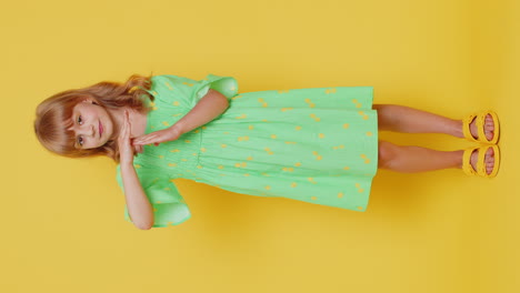 tired serious upset blonde child girl in dress showing pause gesture, limit or stop sign, time out