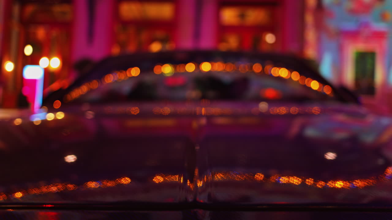 Blurred view of a car parked in the courtyard of the Monte Carlo Casino in the evening in Monaco