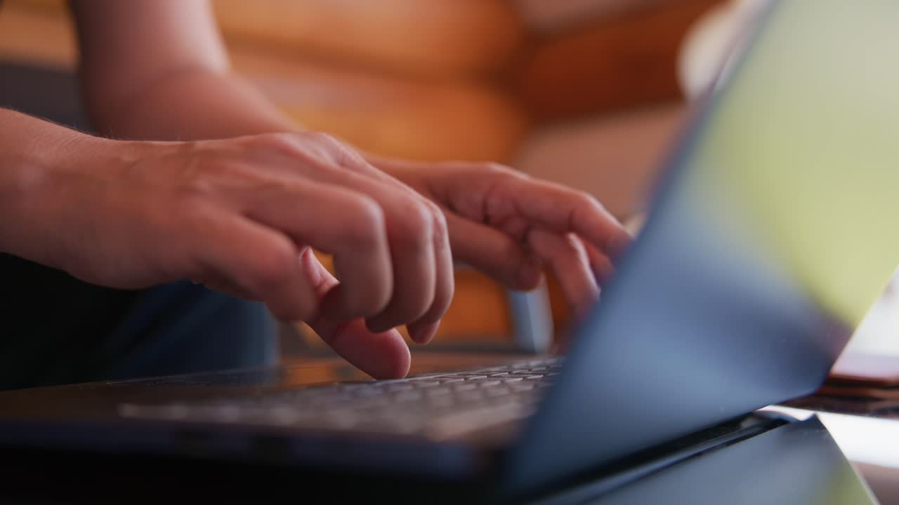 Close-up of Hands Typing on Laptop Keyboard