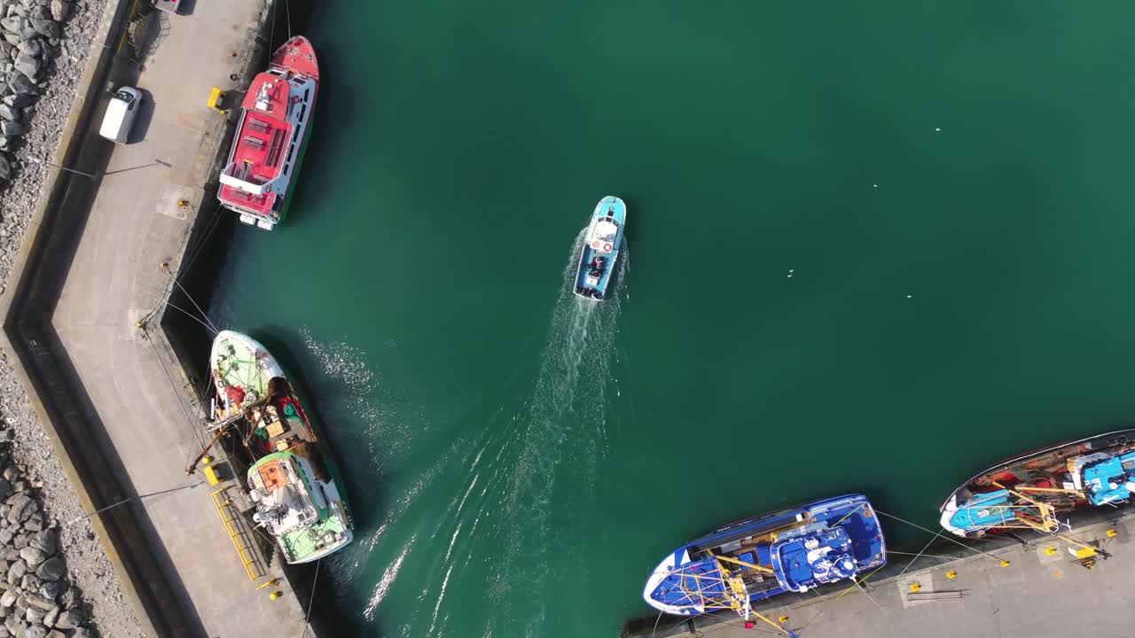 4K cinematic drone footage capturing Kilmore Quay, on a bright day, showcasing the picturesque harbour, and colourful fishing boats Co.Wexford - Ireland_013