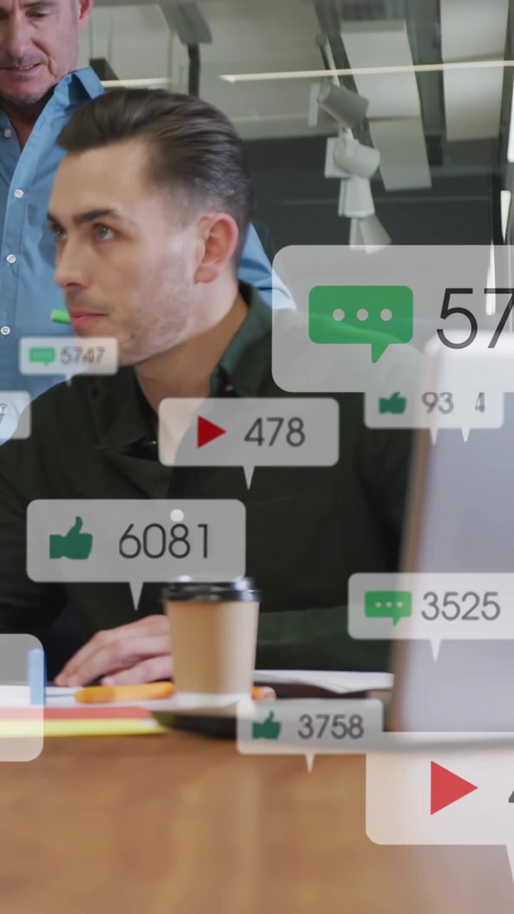 Vertical video: Man hearing senior while bubbles from laptop drifting across desk for marketing