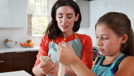 Girl-and-mother-preparing-dough-for-challah-bread,-close-up