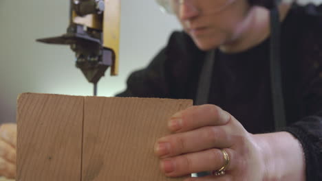 bespoke shoemaker cutting wooden last for shoe using jigsaw