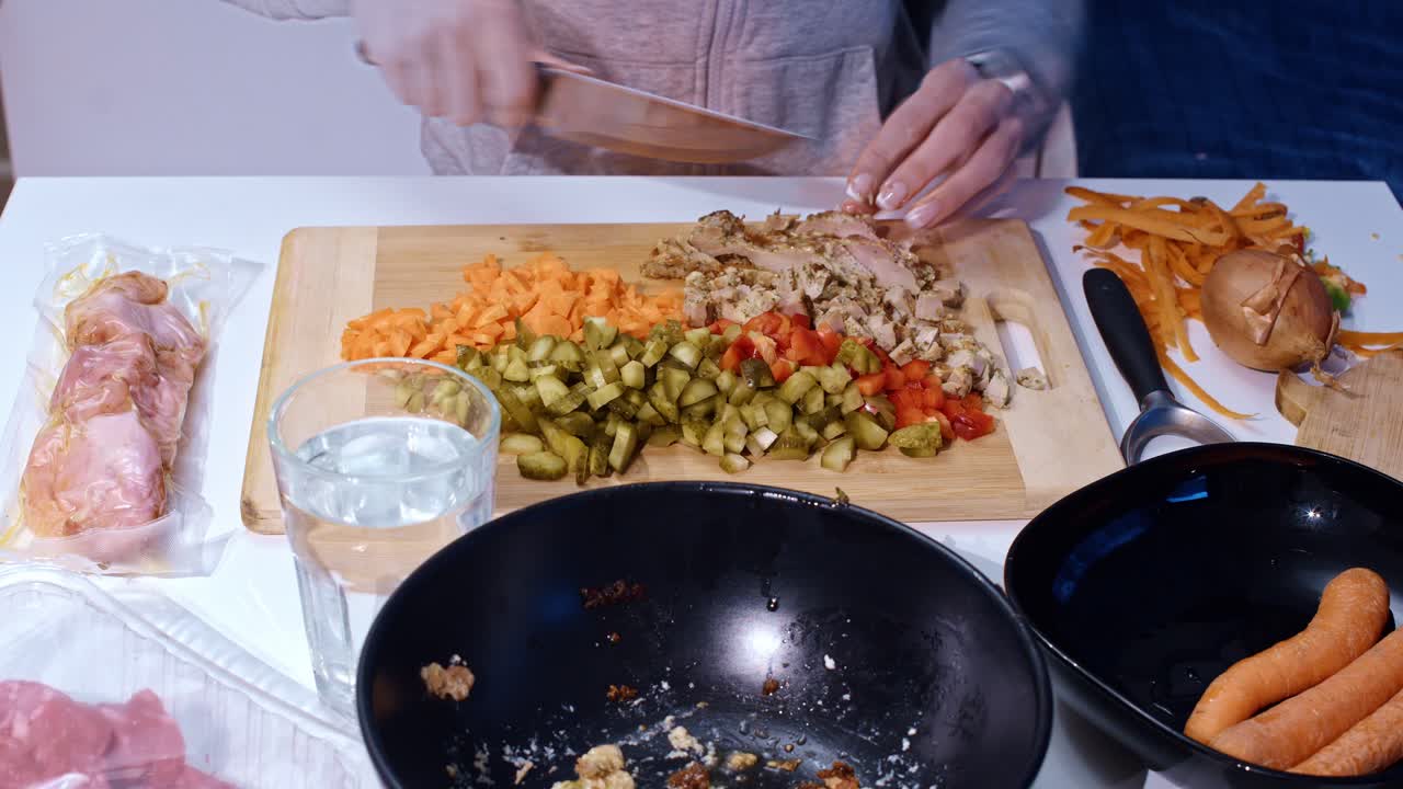 Timelapse of woman slicing vegetables with slow zoom while prepping soup meal