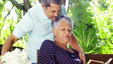 Senior-couple-kissing-each-other-in-garden-