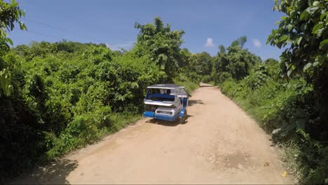 Riding-bike-on-ground-roan-in-Philippines-following-the-tricycle