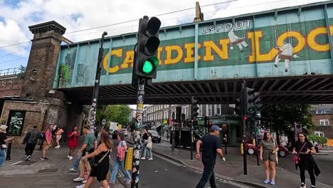 pedestrians crossing under camden lock bridge