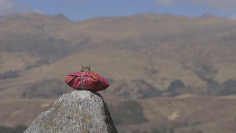 ceremonial bundle sits atop a stone in peru