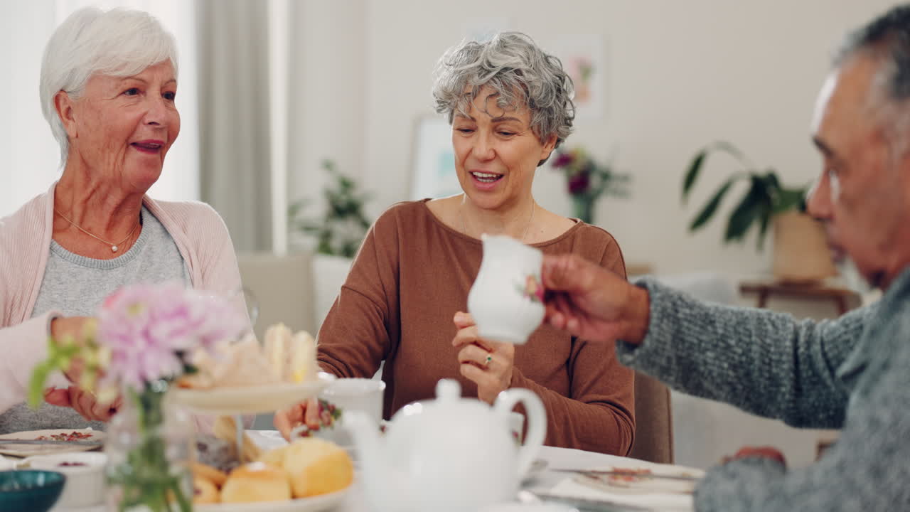 Senior man, women and pouring milk at tea party