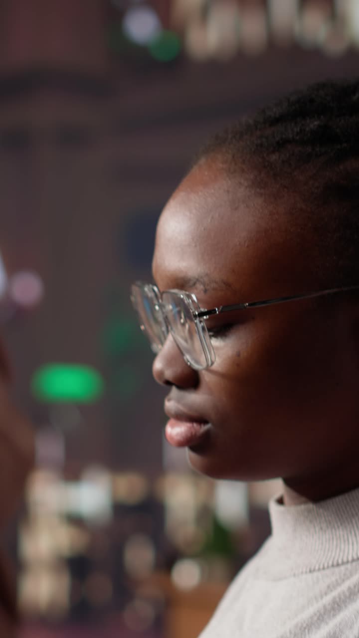 Vertical video african american student consulting academic research collection at library