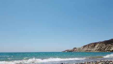 gentle sea waves roll onto the shore at pissouri bay, cyprus. captured during a peaceful local walk by the beach, showing coastal charm, blue waters, and mediterranean calm.