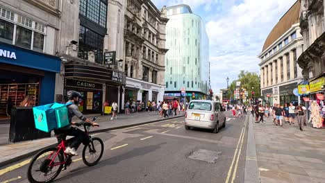 pedestrians and vehicles on a bustling london street