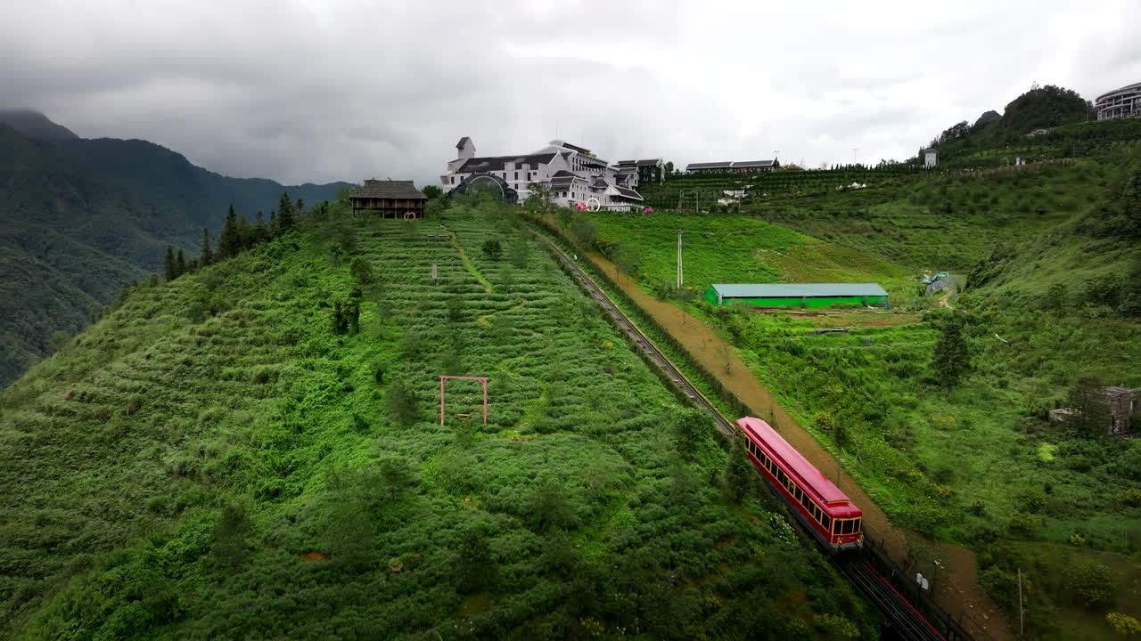 Scenic Mountaintop Hotel with Train and Lush Greenery
