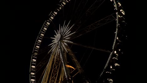 budapest hungary - beautiful scenery of a large illuminated ferris wheel during nighttime - tilt up shot