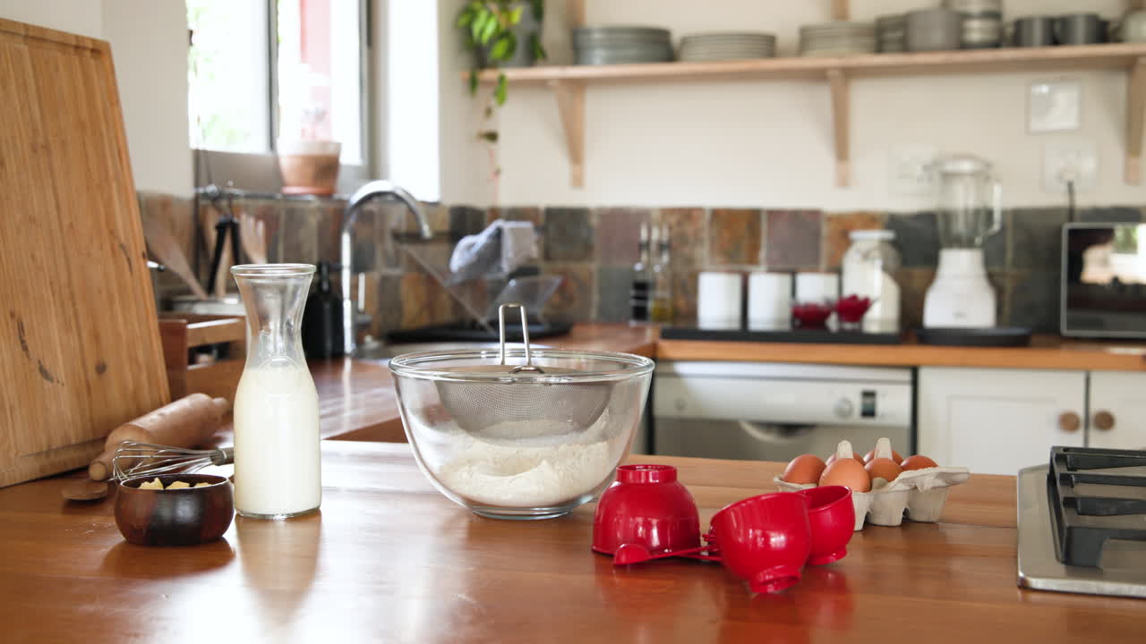 Mixing flour, milk, and eggs, woman preparing dessert in cozy kitchen