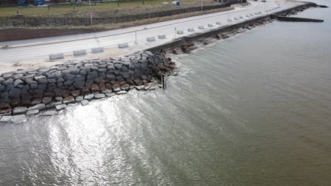 Drone-approaching-the-stone-levees-on-Lake-Michigan's-Eastern-coast