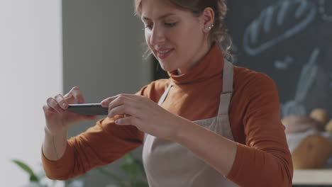 woman taking a photo of food