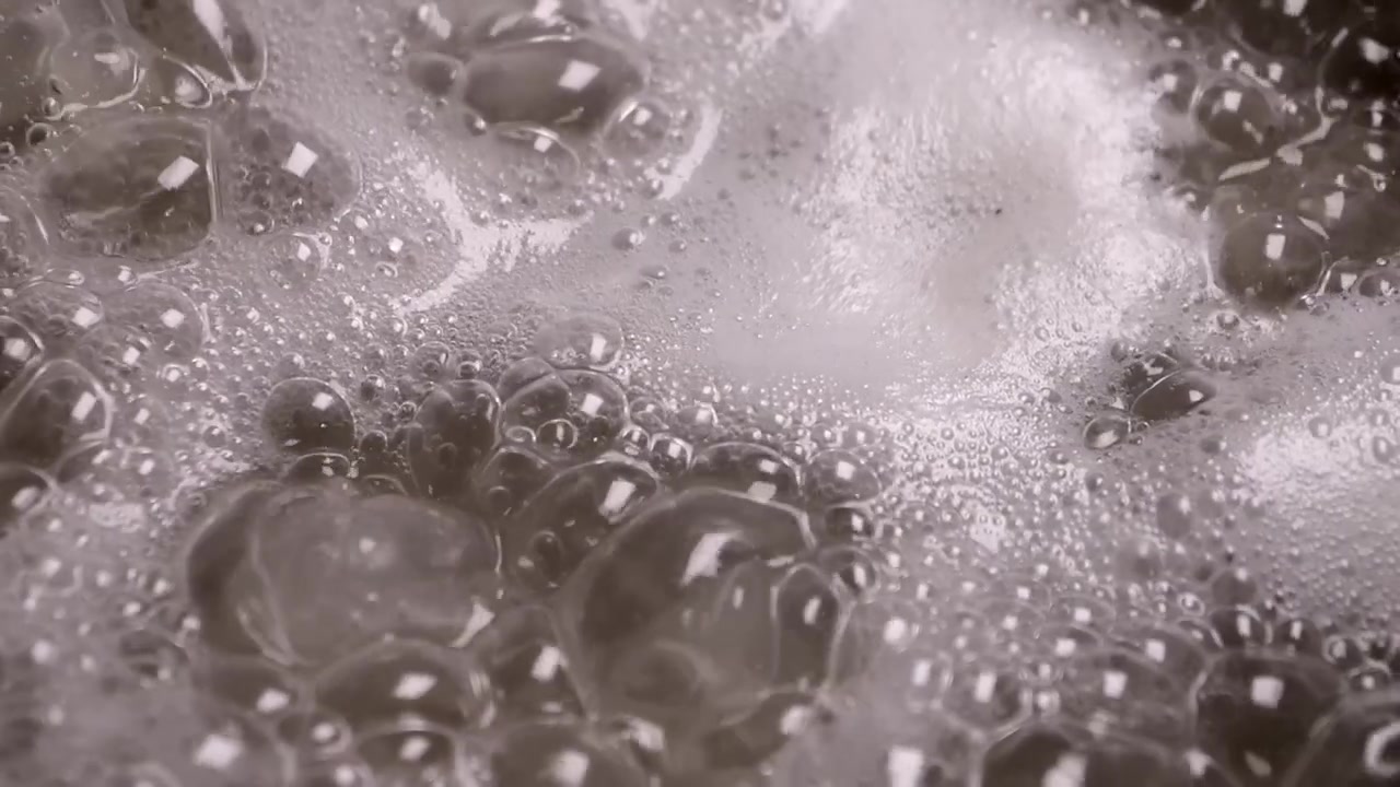 Boiling water with brine and bubbles in a saucepan.