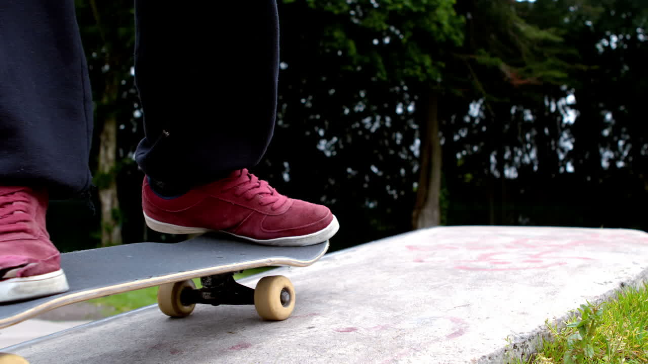 Young skateboarder skating the outdoor skatepark