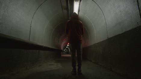parkour athlete freerunning in concrete tunnel