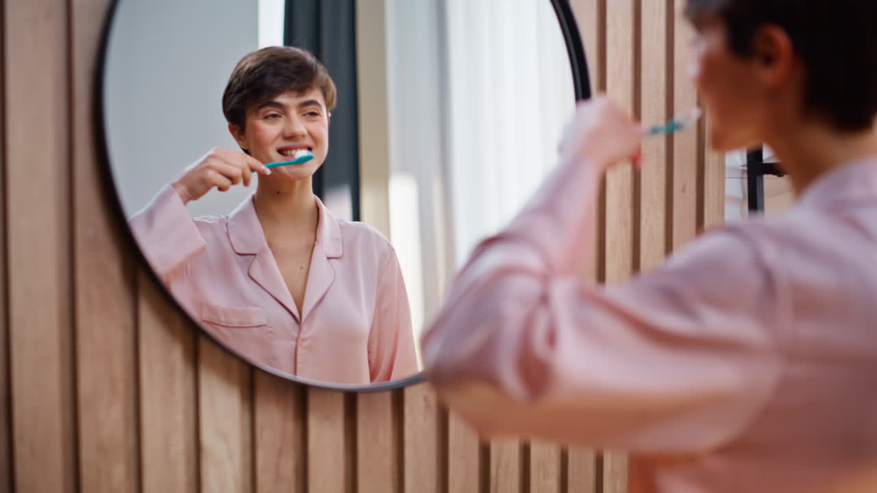 Lady hand applying toothpaste at brush indoors closeup. Woman brushing teeth