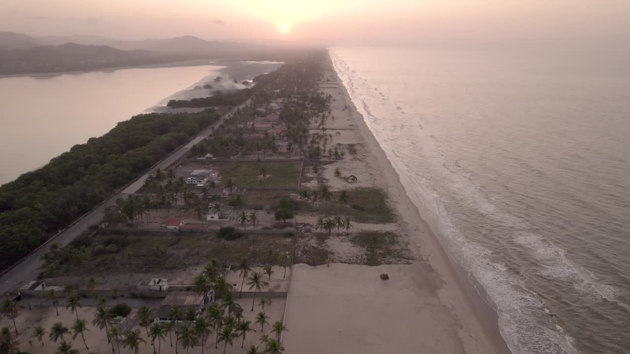 Drone flying over an isthmus in the Caribbean sea during sunset