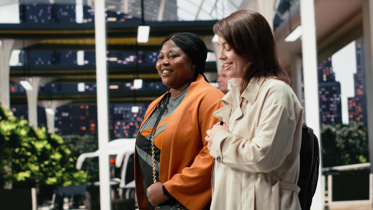 Women travelers walk together through bus terminal