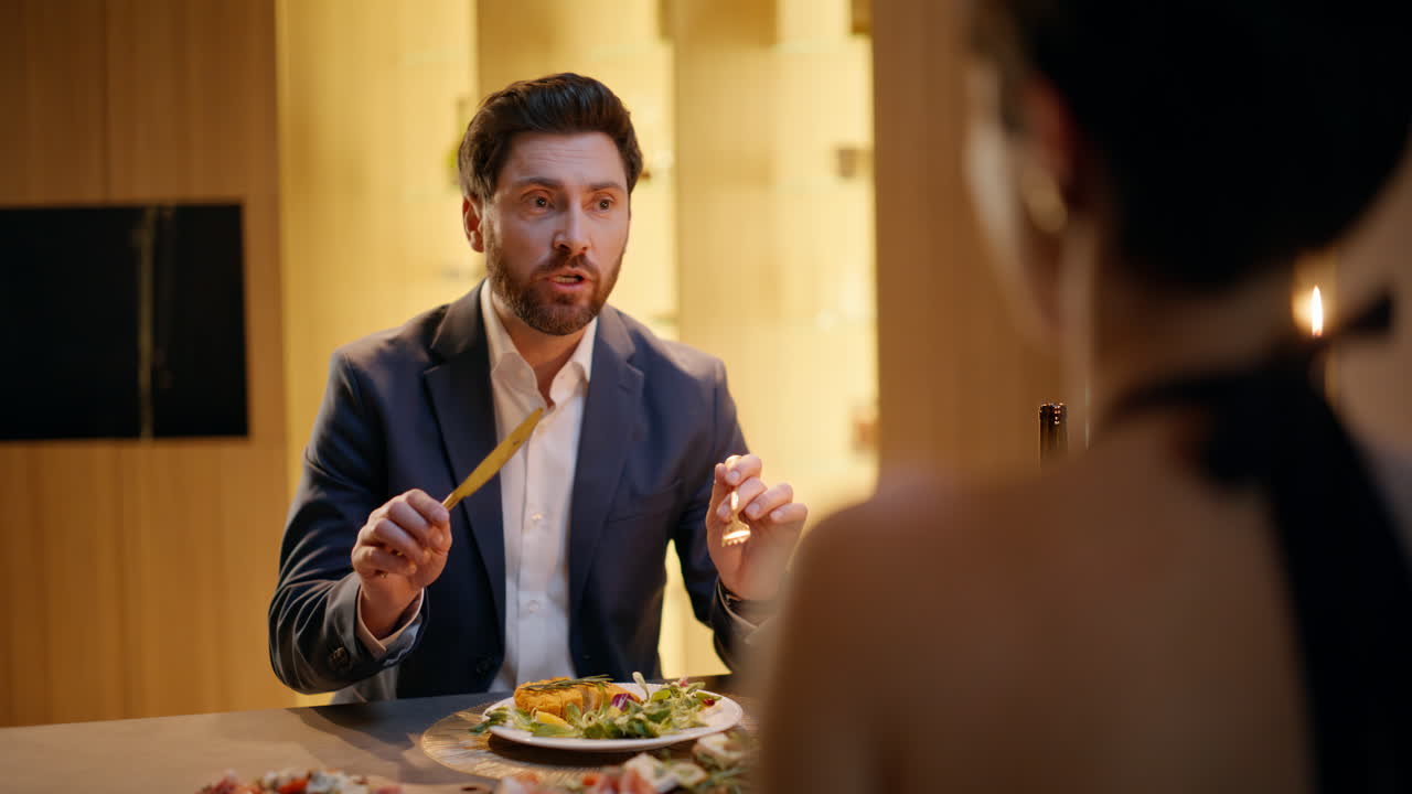 Affectionate man speaking woman confessing in love at apartment dinner closeup