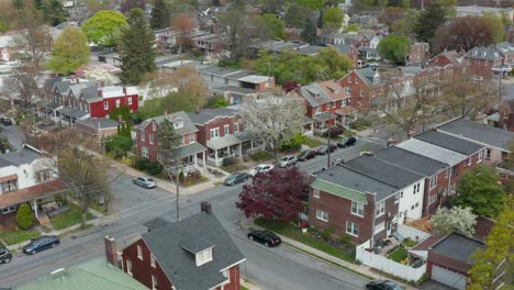 descending aerial establishing shot of homes in city