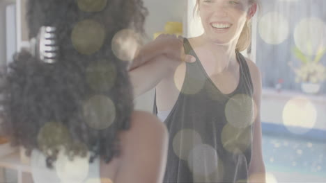 Animation-of-light-spots-over-happy-diverse-teenage-girls-practicing-yoga-together