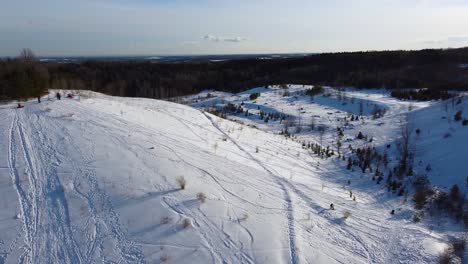 snowboarders riding downhill snow slope during winter outdoors