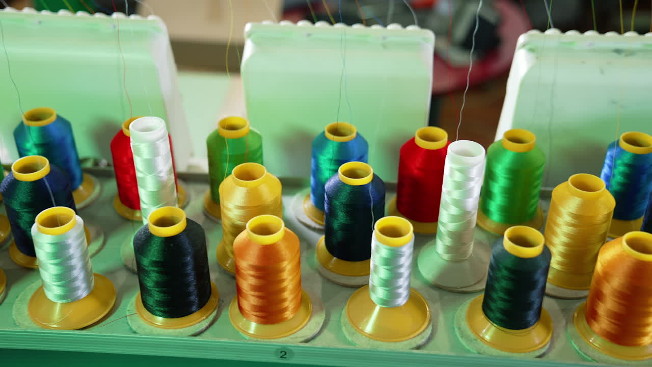Collection of colorful spools for a dressmaker. Sewing tools for handicraft job. Spools of thread of different colors for tailor.